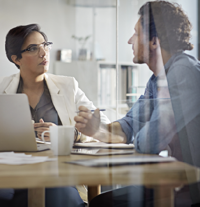 A bid writer and bid skills trainer in an office working on a bid.